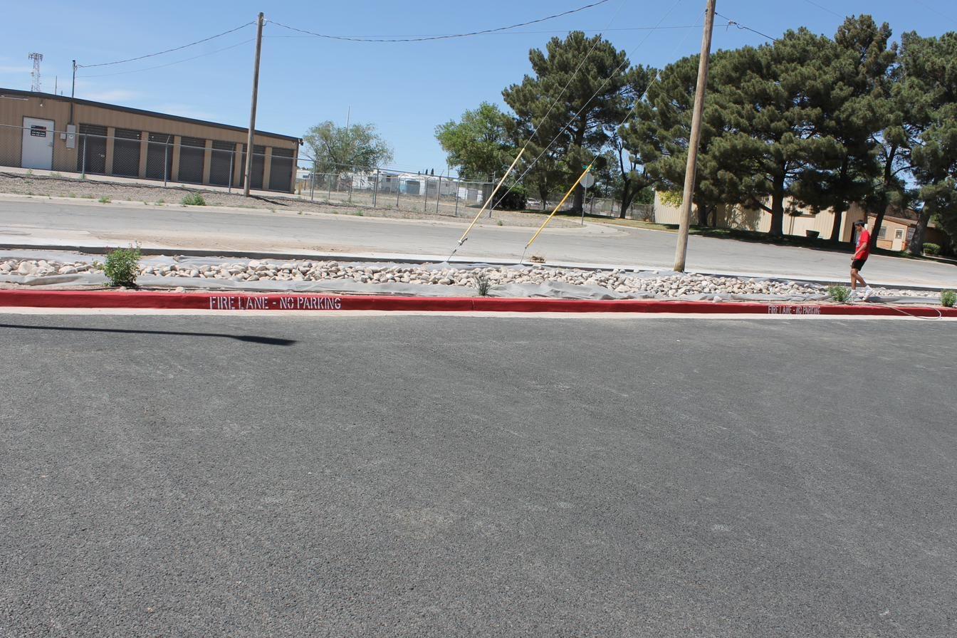 Close detail of fresh fire lane curb painting with stenciled text