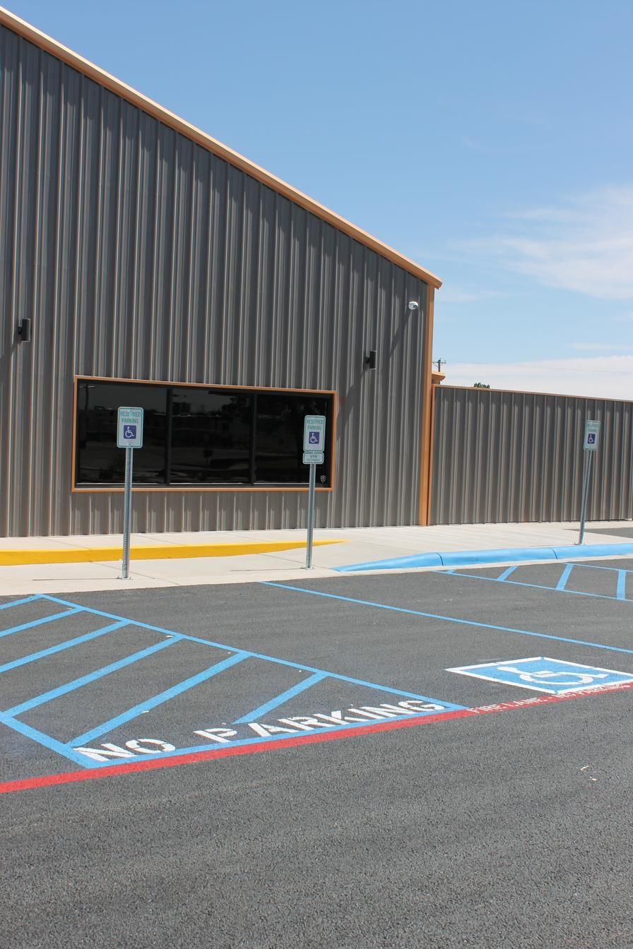 Detail of ADA handicap stencil with diagonal blue access aisle stripes
